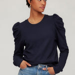 Top with puff sleeves and a clean, modern silhouette