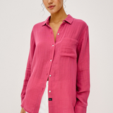 women in pink button down on white background 