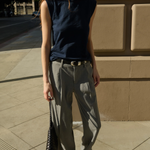 Model wearing a navy sleeveless muscle tank with a relaxed fit.