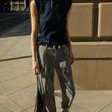 Model wearing a navy sleeveless muscle tank with a relaxed fit.
