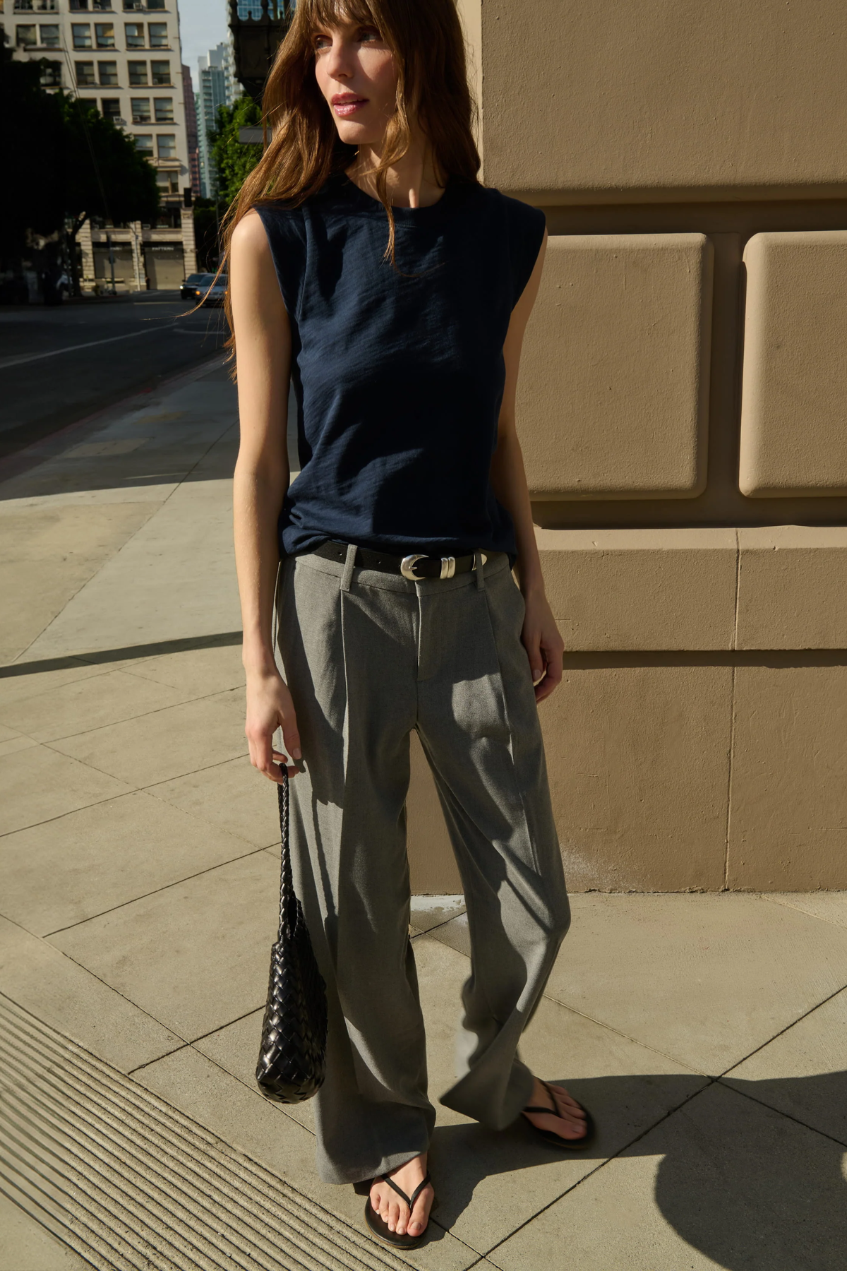 Model wearing a navy sleeveless muscle tank with a relaxed fit.