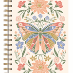A spiral-bound notebook with a cream-colored cover featuring a colorful butterfly and floral design, bound with gold-toned metal coils on the left side.