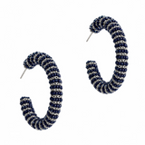 A pair of open hoop earrings with a textured spiral pattern in navy blue and silver, shown on a plain white background.