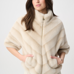 Woman wearing a cream-colored fur vest on a white background