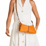 Woman wearing a white dress with a brown leather crossbody bag.