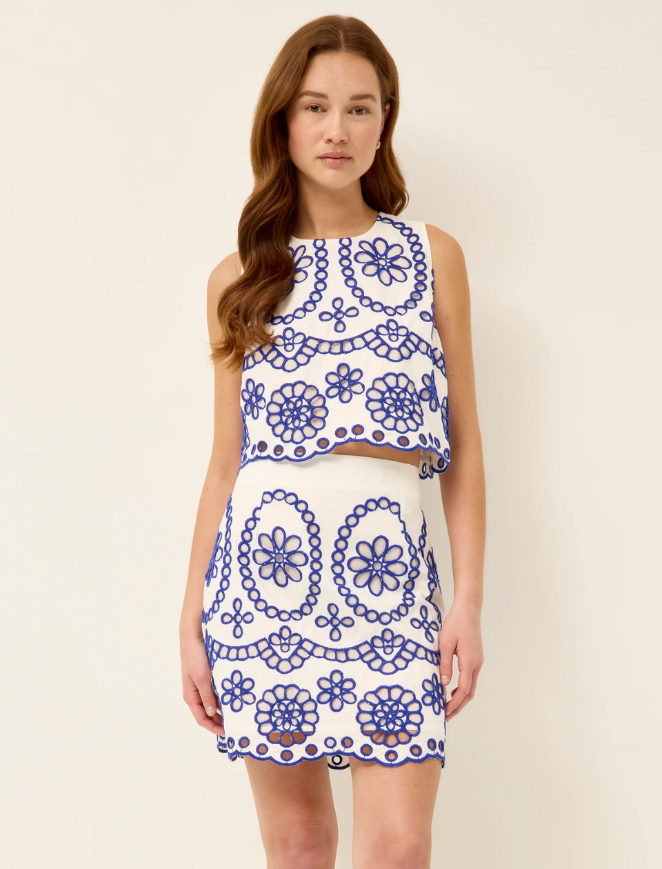 woman in blue and white set on tan background