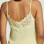 Yellow lace-trimmed camisole worn by a model on a plain background