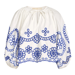 White blouse with blue floral embroidery on a white background