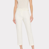 Woman wearing a white sleeveless top and pants on a white background