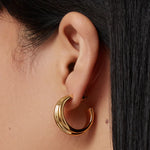 Gold hoop earrings with a smooth, polished finish.