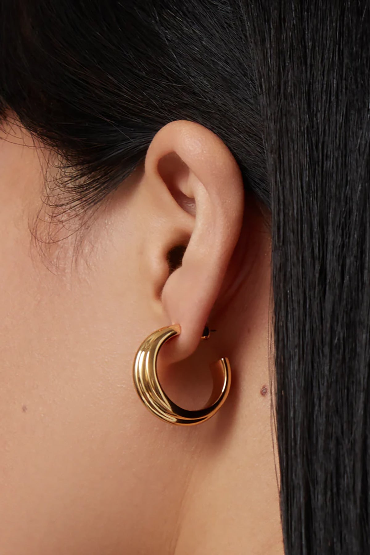 Gold hoop earrings with a smooth, polished finish.