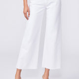 Person wearing white wide-leg jeans on a plain background