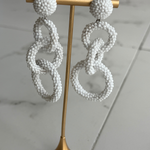 white linked drop earrings with three open circular shapes in a contemporary statement silhouette.