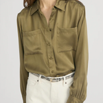 Model wearing an olive green utility button-front shirt with chest pockets and long sleeves.