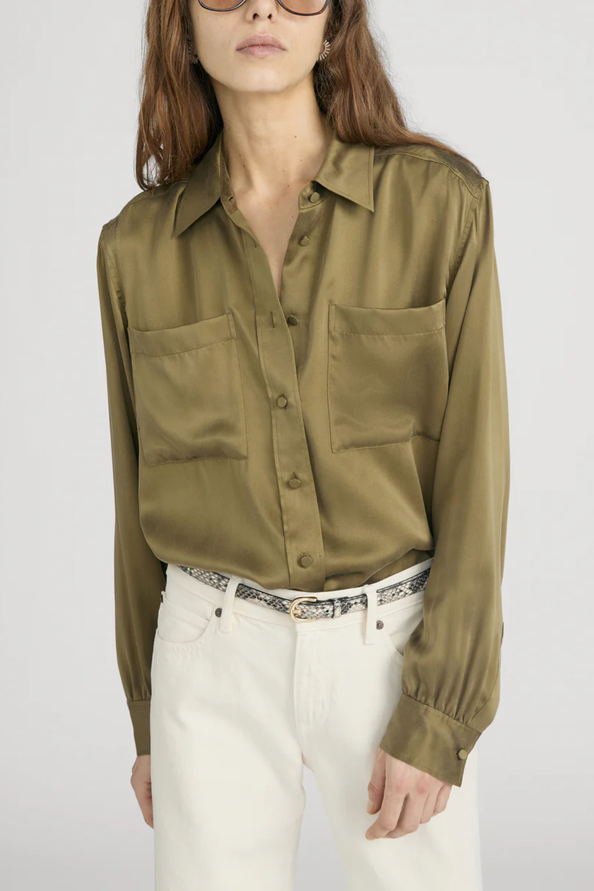 Model wearing an olive green utility button-front shirt with chest pockets and long sleeves.