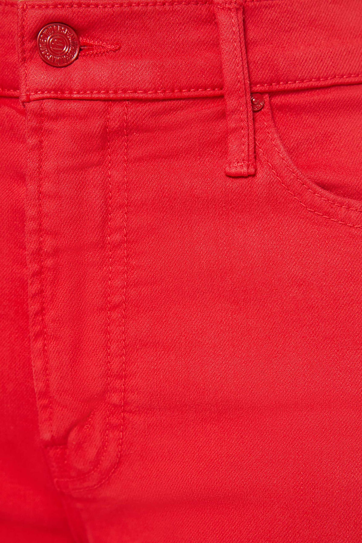 Close-up of a red fabric with a button and stitching details.