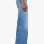 Model wearing light-wash denim jeans with twisted seam detailing and a relaxed straight-leg fit.