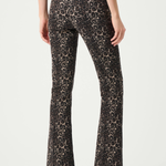 A model shown from the back wearing high-waisted leopard-print flare pants in brown and beige, paired with a black top and black pointed-toe heels.