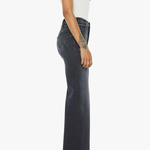 Person wearing dark flared jeans and a white top on a white background