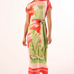 Woman wearing a colorful floral dress on a white background