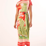 Woman wearing a colorful floral dress on a white background