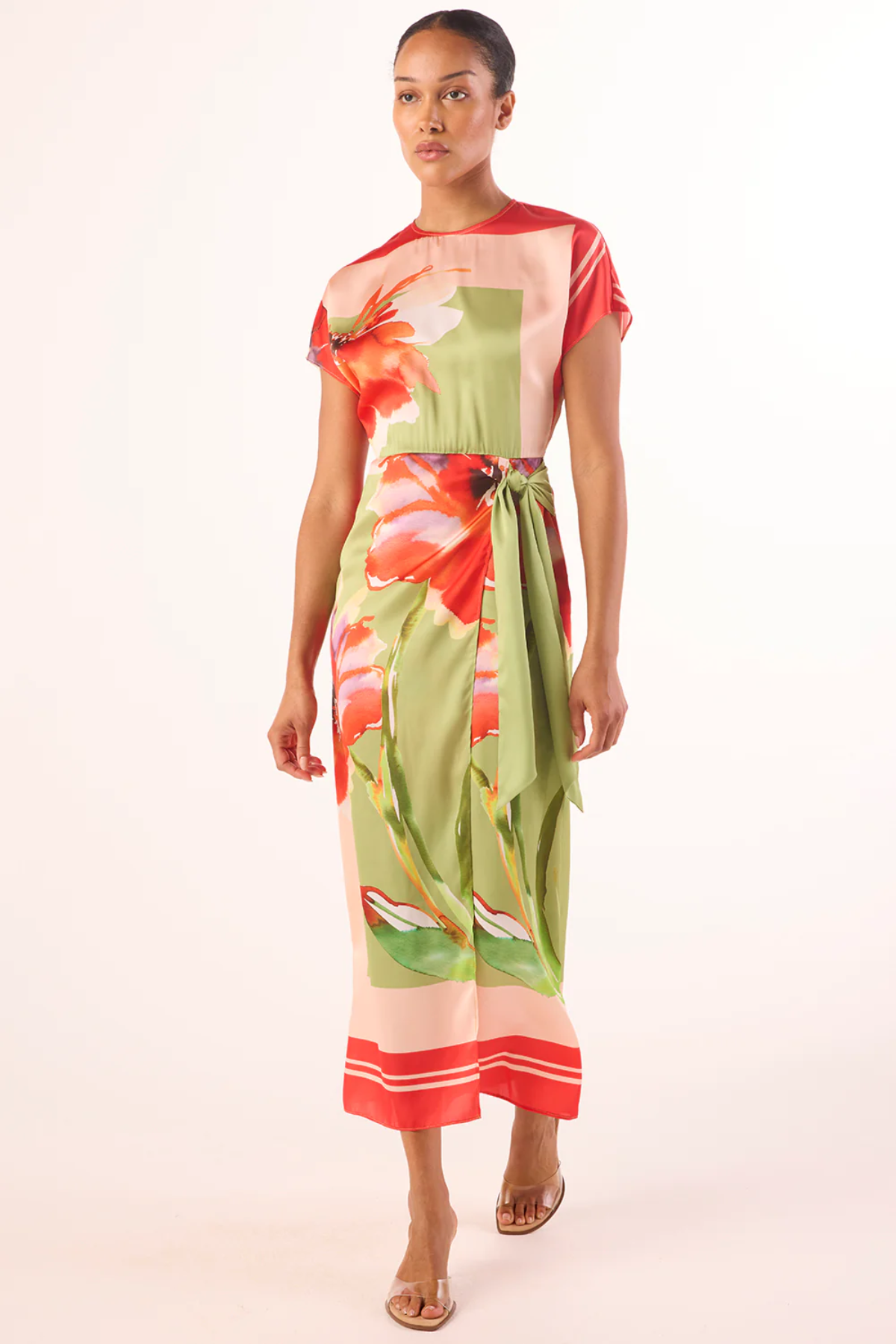 Woman wearing a colorful floral dress on a white background
