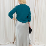 silky slip skirt with a soft drape, styled with a sweater