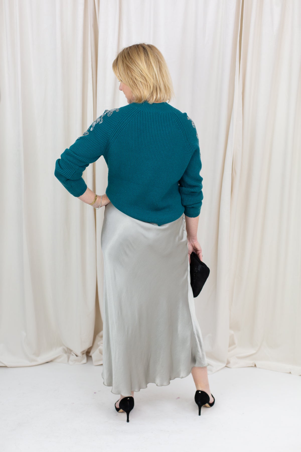 silky slip skirt with a soft drape, styled with a sweater