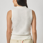 woman in white sleeveless top from the back