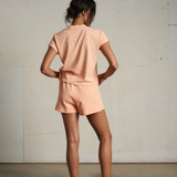 back of woman in peach set 