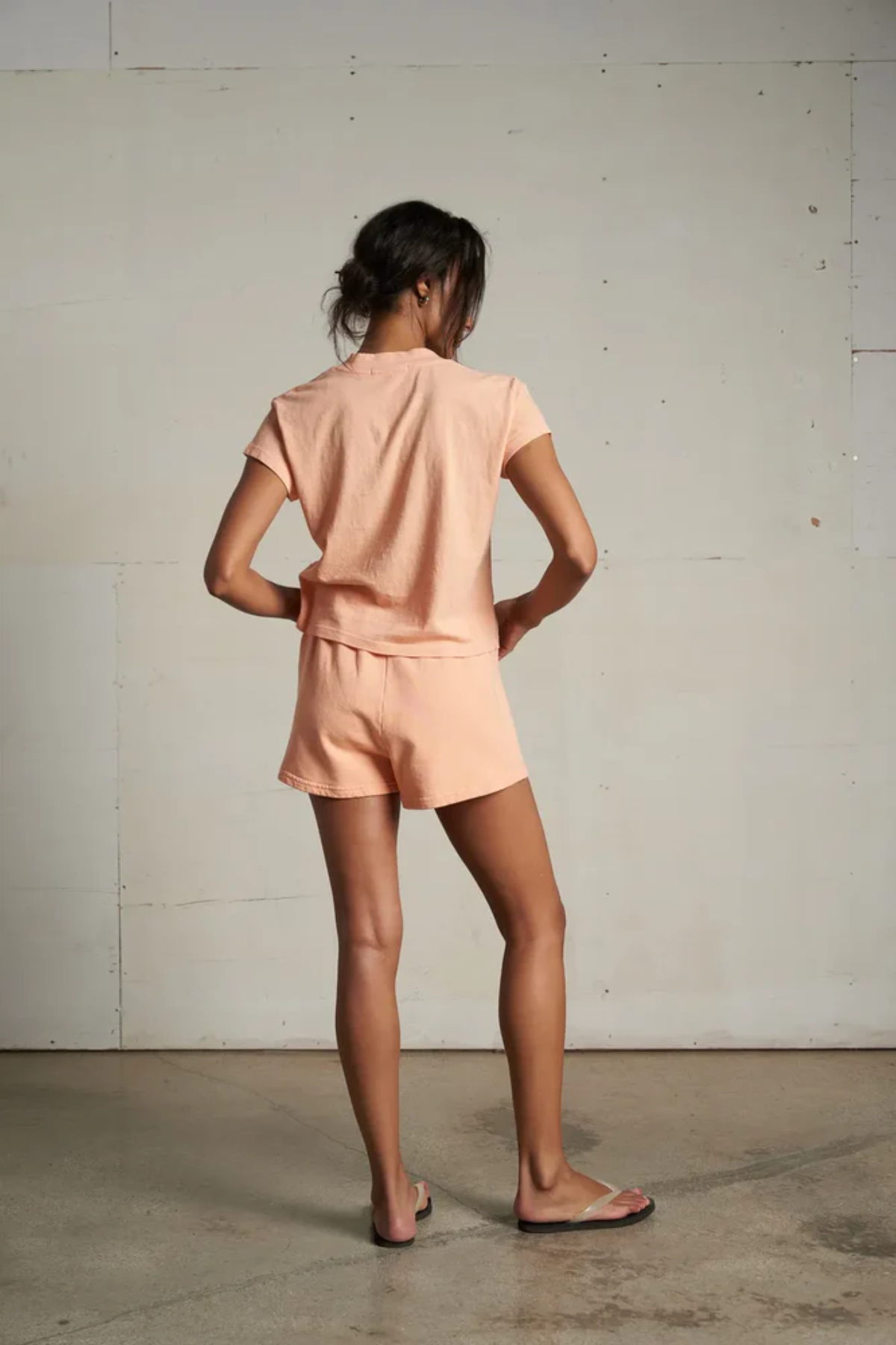 back of woman in peach set 