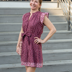 Woman in a patterned dress standing on outdoor steps