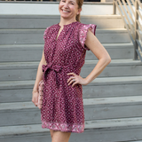 Woman in a patterned dress standing on outdoor steps