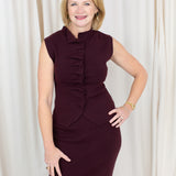 Coordinated burgundy pleated top and skirt set styled for a polished seasonal look