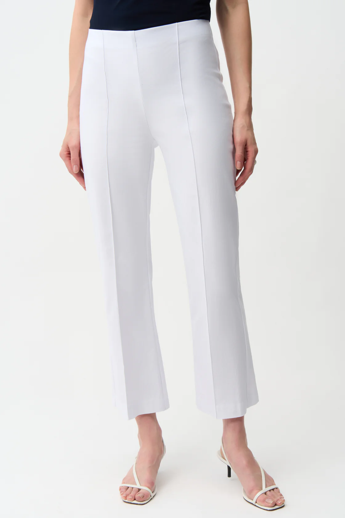 White pants worn by a person on a white background