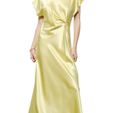 Woman wearing a light yellow satin dress on a white background