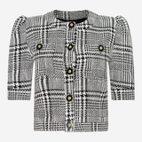 A black and white plaid tweed jacket with puff sleeves, a round neckline, and decorative gold-tone buttons on the front and chest pockets, shown against a plain light gray background.