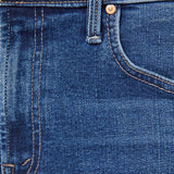 Close-up of blue jeans with stitching and button details