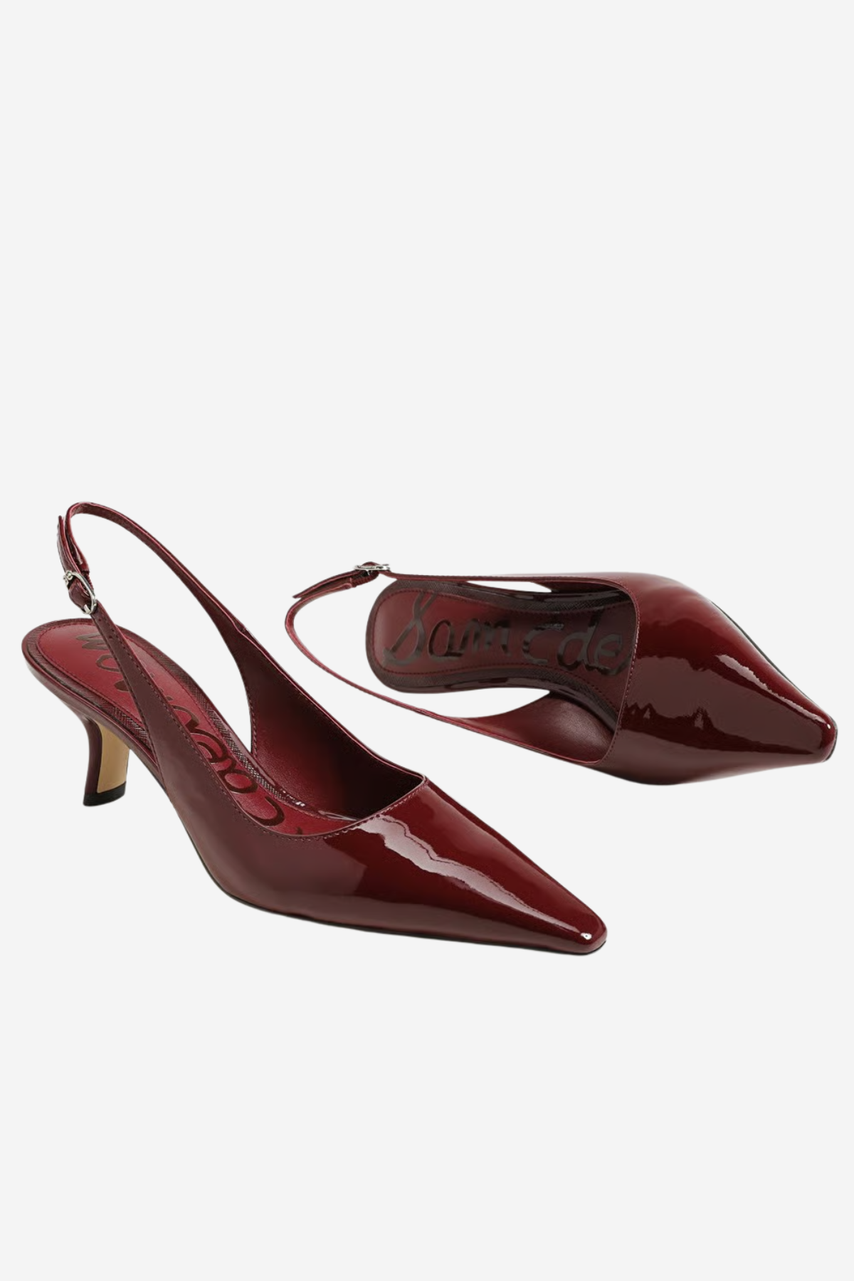A pair of glossy patent leather slingback pumps in a deep burgundy red, displayed on a clean white background.
