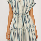 Woman wearing a striped dress with a white background