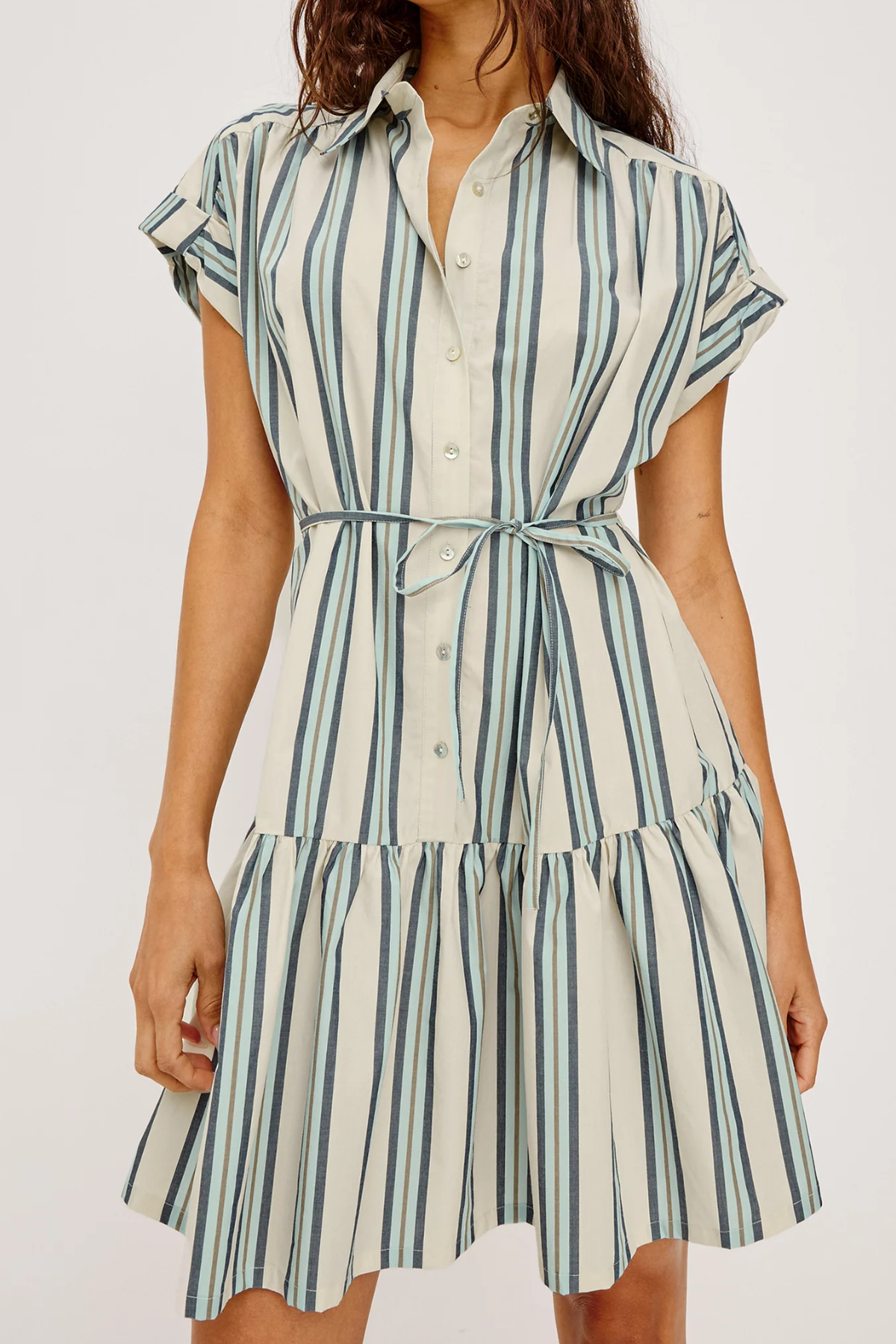 Woman wearing a striped dress with a white background