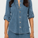 Women's blue denim button-front shirt featuring a collared neckline and long sleeves.