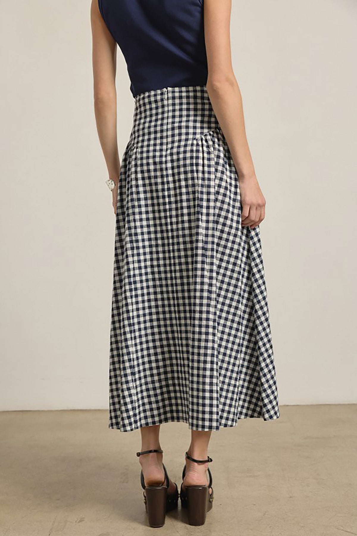woman in checkered gingham midi skirt 