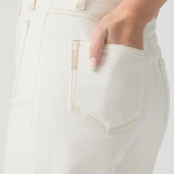 Close-up of a person wearing light-colored pants with a neutral background