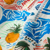 Colorful fabric with pineapple and beach-themed patterns