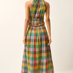 Woman wearing a colorful plaid dress on a white background
