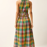 Woman wearing a colorful plaid dress on a white background