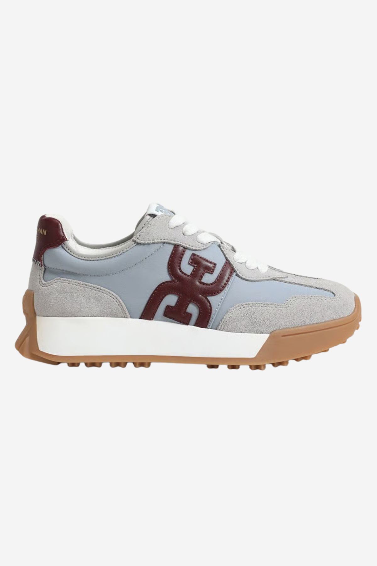 A light blue suede and mesh sneaker with a large dark red 'GG' logo on the side, white laces, a white midsole, and a brown gum outsole, shown against a light gray background.