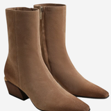 A pair of taupe brown suede ankle boots with pointed toes and low block heels, shown on a light gray background.