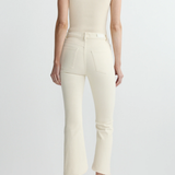 back view of woman in cream outfit on white background 